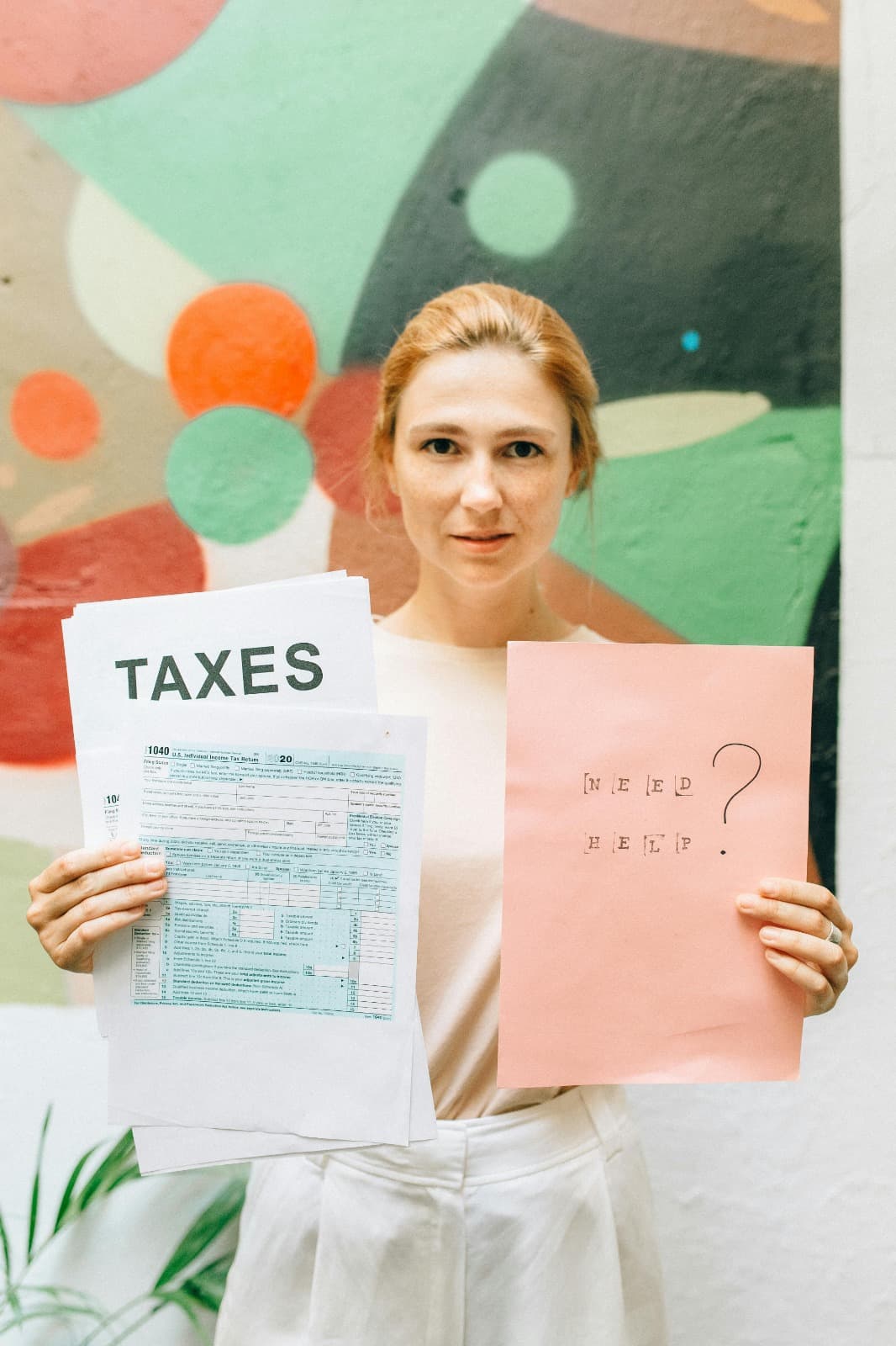 Professional holding tax documents with need help message